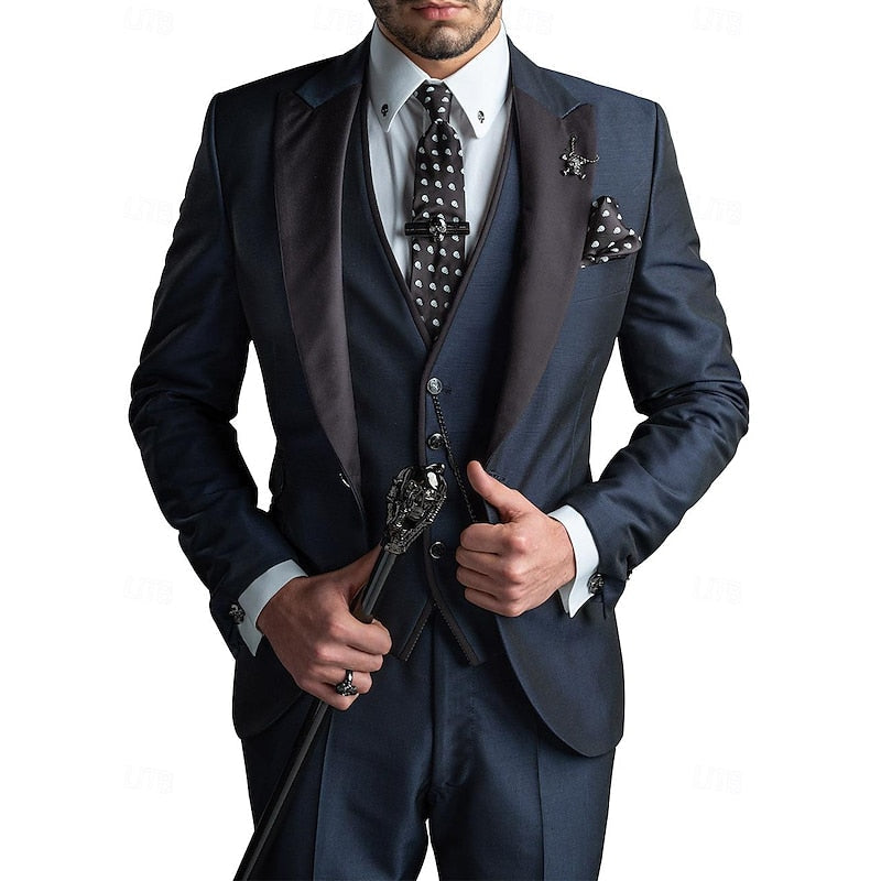 Men's three-piece suit in navy with black satin peak lapels, polka-dot tie, pocket square and cane.