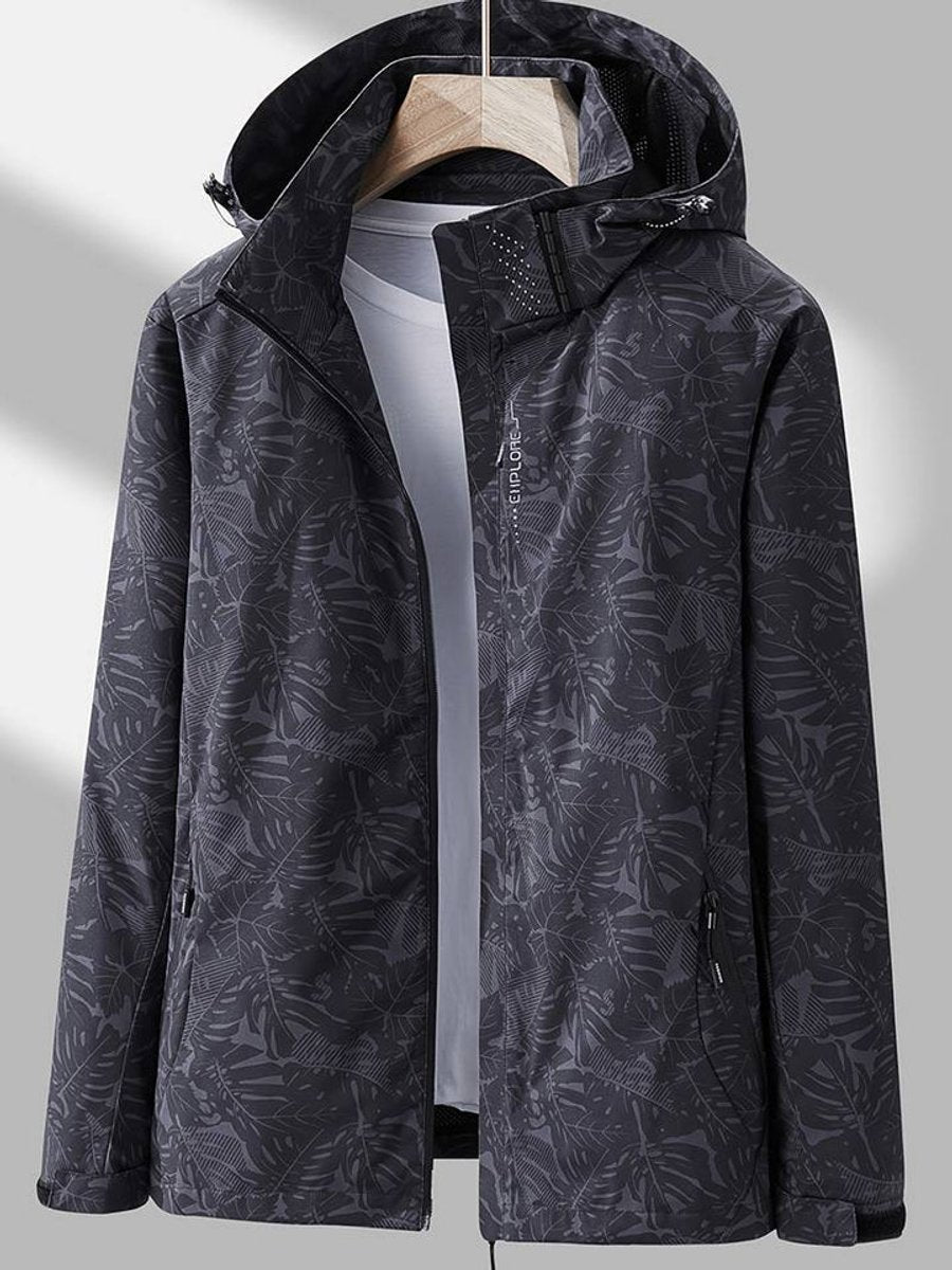 Dark charcoal gray jacket with a subtle leaf print, hanging open over a gray tee, with a hood and zippered hand pockets. 6