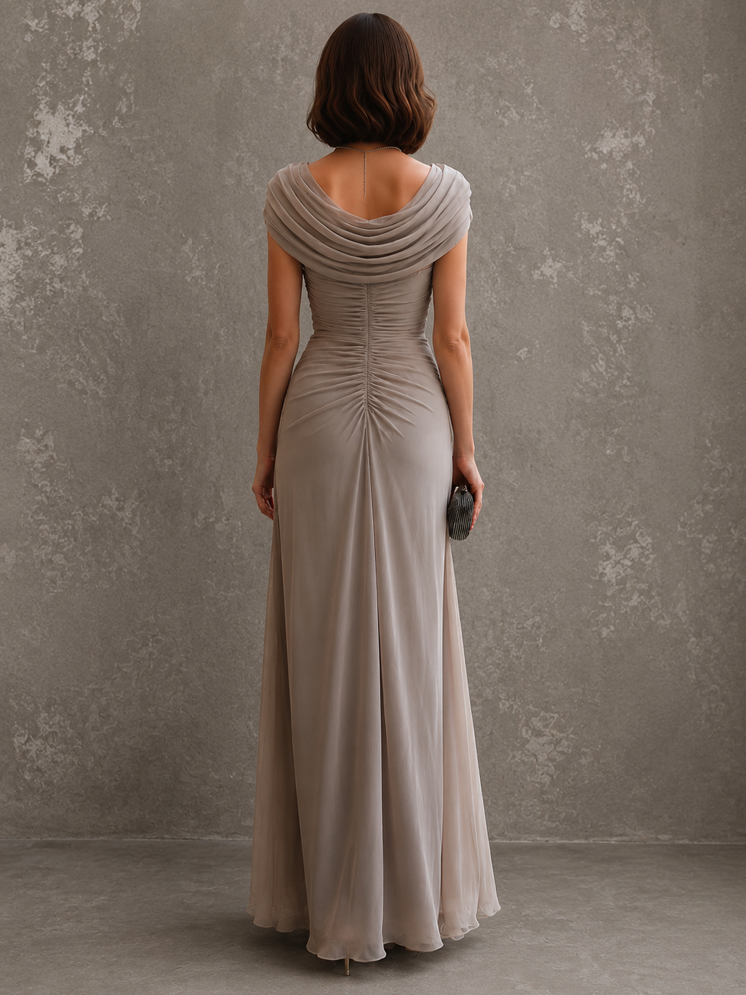 Back view of the beige dress, showing the draped cowl back neckline and vertical ruching down the center of the back.
