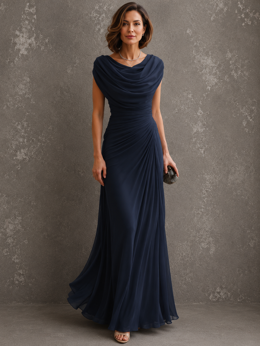 Model in the beige dress, with draped cowl neckline, ruched waist and floor-length skirt.