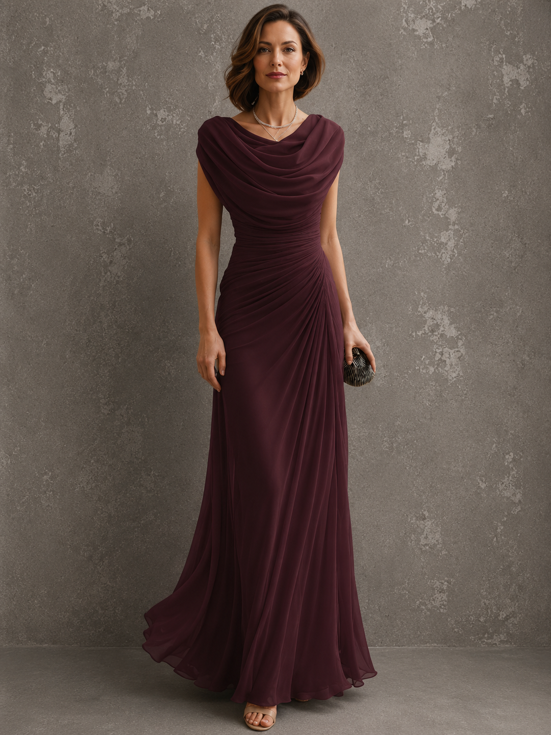 Model in the beige dress, showing the draped neckline, ruched waist and long flowing skirt.