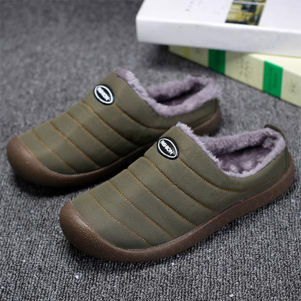 Olive green quilted slip-on slippers with fleece lining, seen from above on carpet with books 3