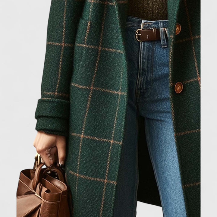 Women's plaid coat detail of the front, rolled cuff and large patch pocket, worn with a brown belt and jeans.