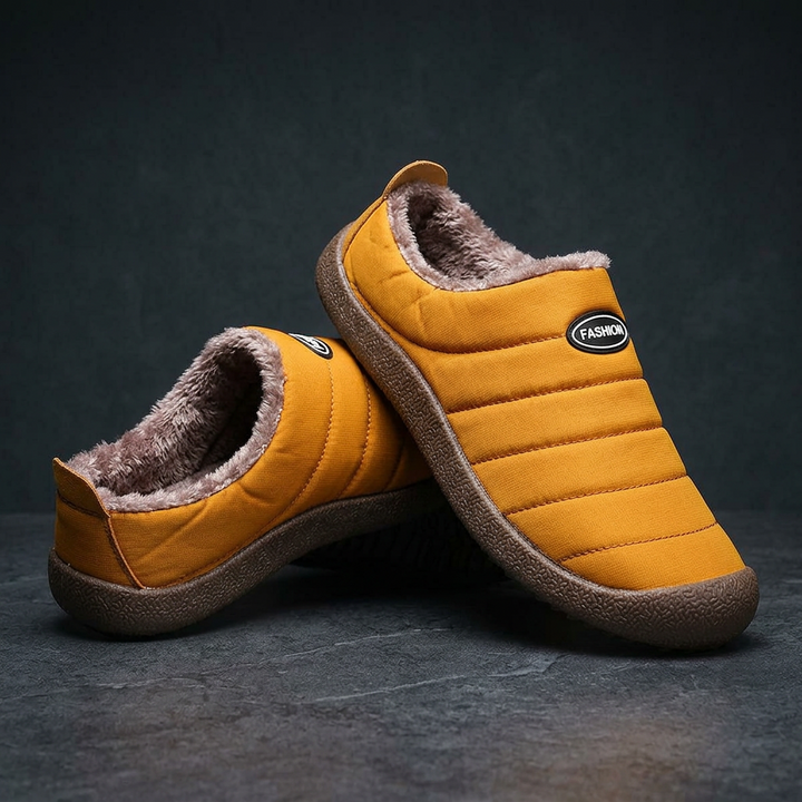Pair of mustard yellow quilted slippers stacked against each other on a dark stone surface 20