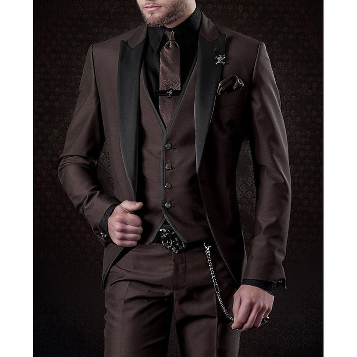 Men's three-piece suit in dark brown with black peak lapels, black shirt, brown tie, pocket square and vest chain.