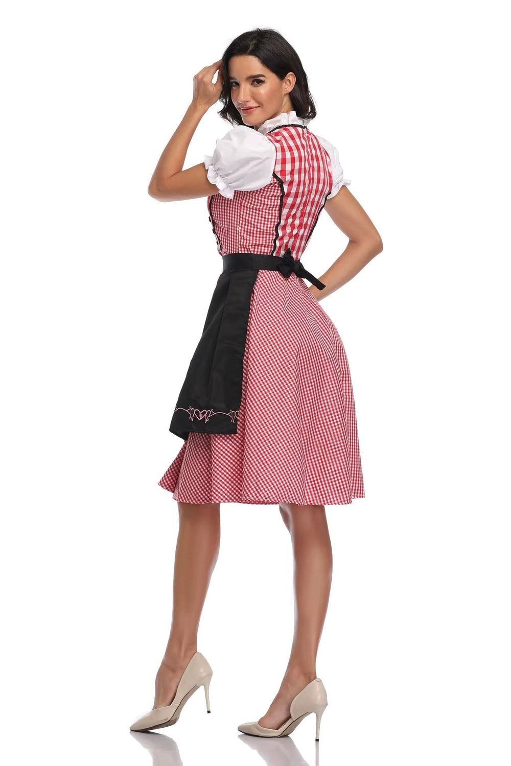 Women's red gingham dirndl back view with a black apron tied at the waist.