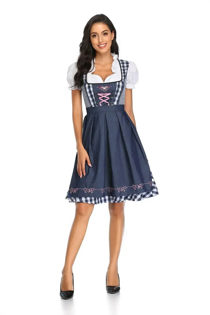 Women's navy and white checked dirndl front view with a navy apron and pink lacing.