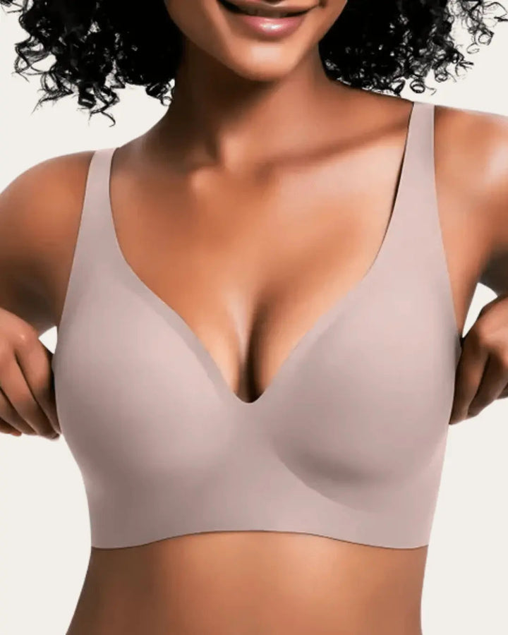 Smooth wireless V-neck bra in soft taupe-pink, front view on a model.