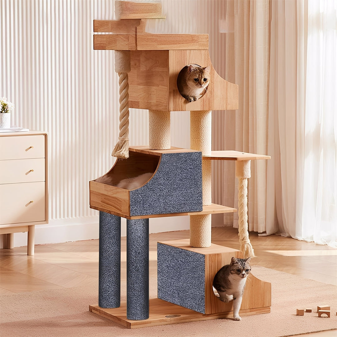 Wooden cat tree in a living room with gray mats covering its posts and house sides, two cats resting inside. 3
