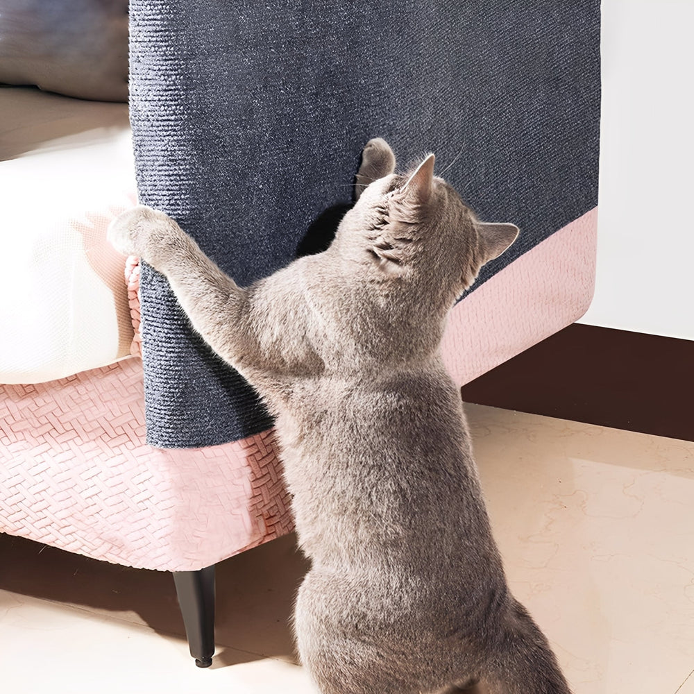Gray cat standing on its hind legs and scratching a gray mat stuck to the armrest of a pink sofa. 2