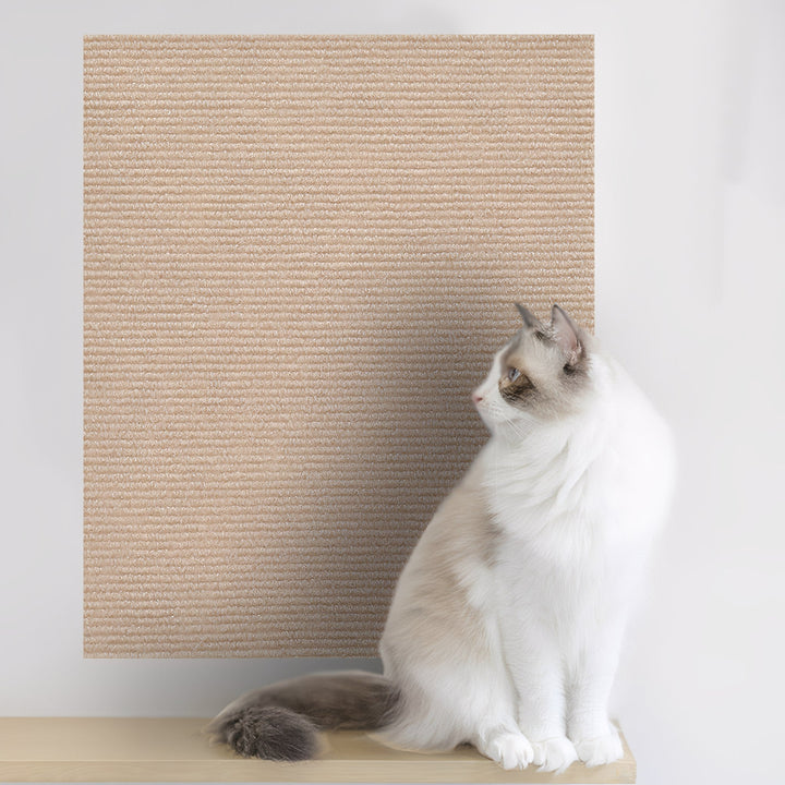 Large beige mat mounted on a white wall above a shelf, with a white cat sitting in front looking at it. 9