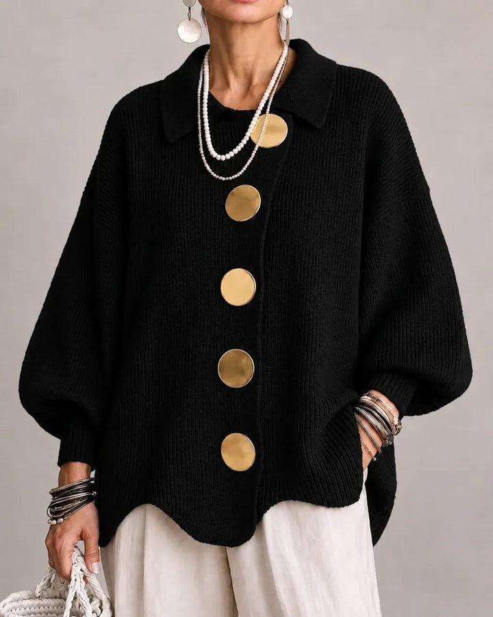 Black ribbed cardigan on a model with five gold round buttons, scalloped hem and white wide-leg pants. 8