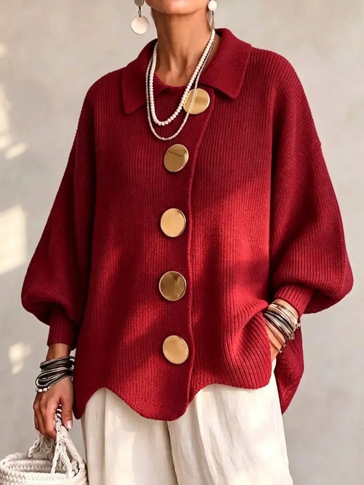 Bright red ribbed cardigan worn by a model in soft sunlight, showing gold buttons and wavy hem. 11