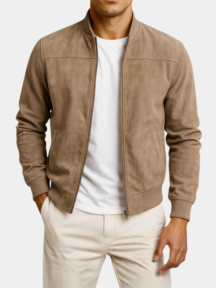 Tan faux suede jacket on a white background, worn unzipped by a model, showing front pockets and ribbed hem.