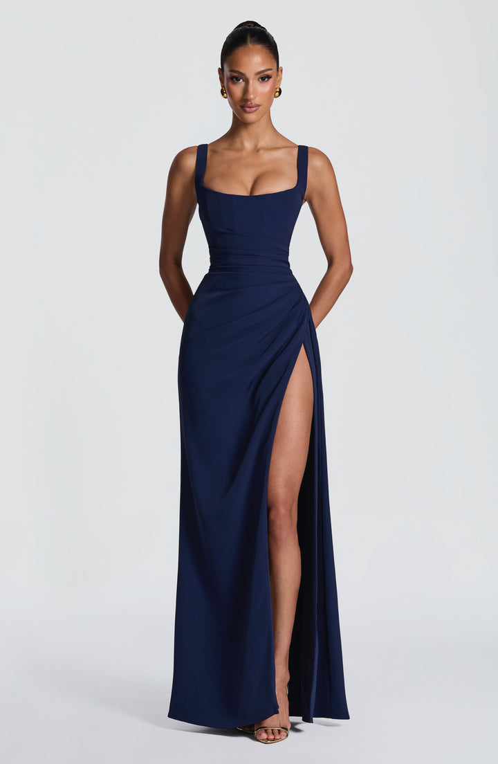 Navy Camille Maxi Dress on a model, front view with square neckline, ruched waist and high slit.