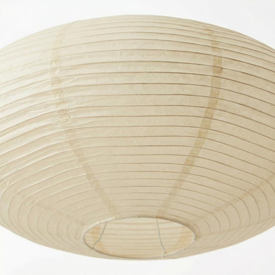 Close-up from below of the ribbed paper shade, showing the seams and the round wire ring of the bottom opening. 5