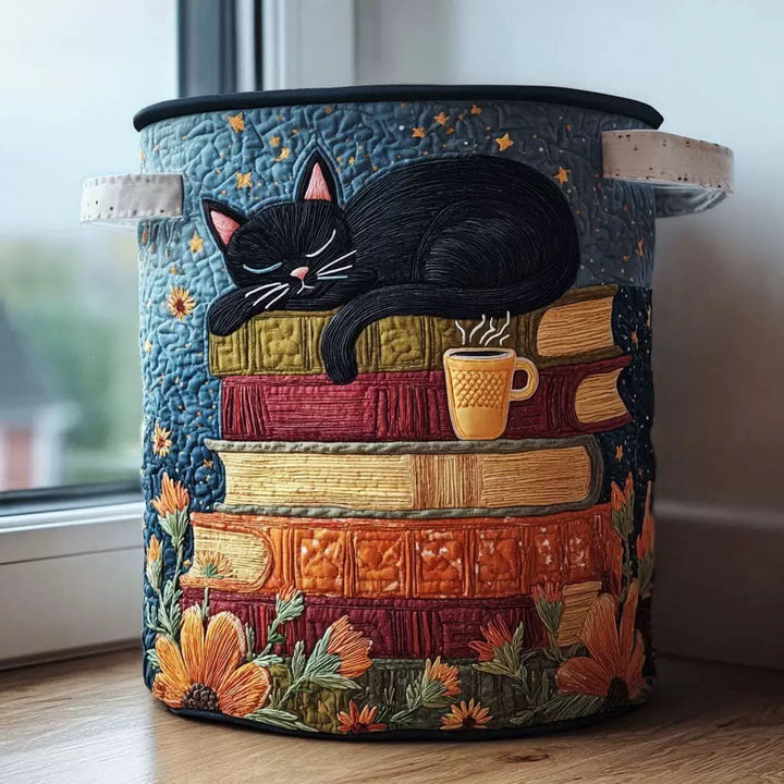 Quilted Cat Library Laundry Basket with Handles in black with cream handles, shown in a lifestyle photo.