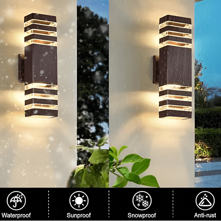 LED Outdoor Wall Light in black and transparent shown outdoors in rain and snow.