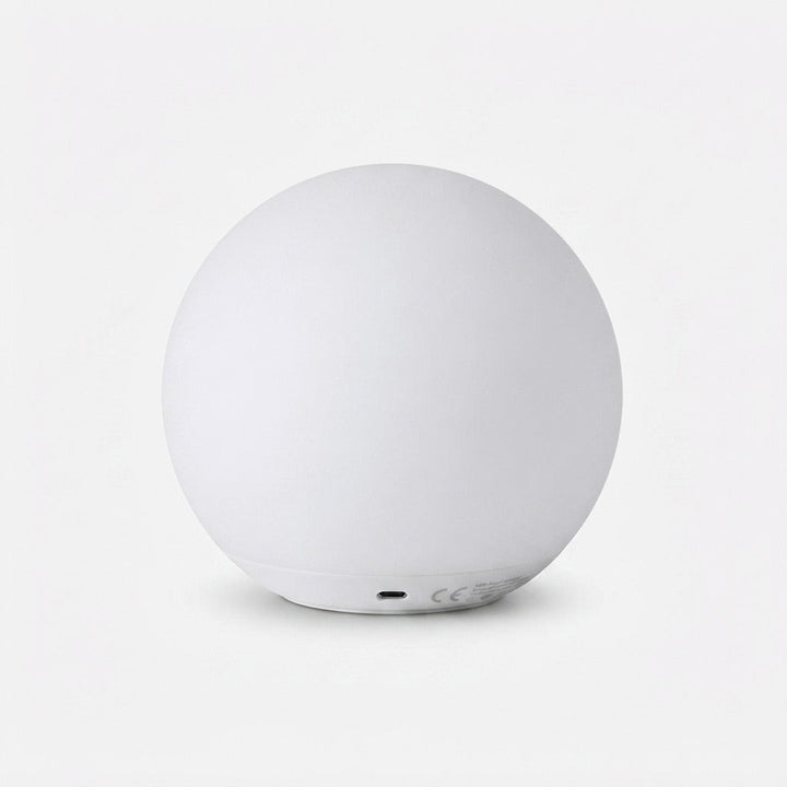 Back view of the white orb lamp showing the charging port on its base
