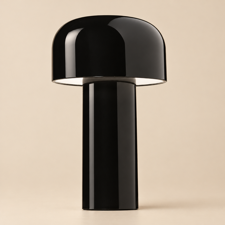 Close-up of the glossy black lamp on a beige background, showing its dome shade and cylindrical stem 33