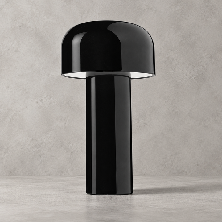 Glossy black lamp with dome shade, photographed on a gray concrete surface and wall 33