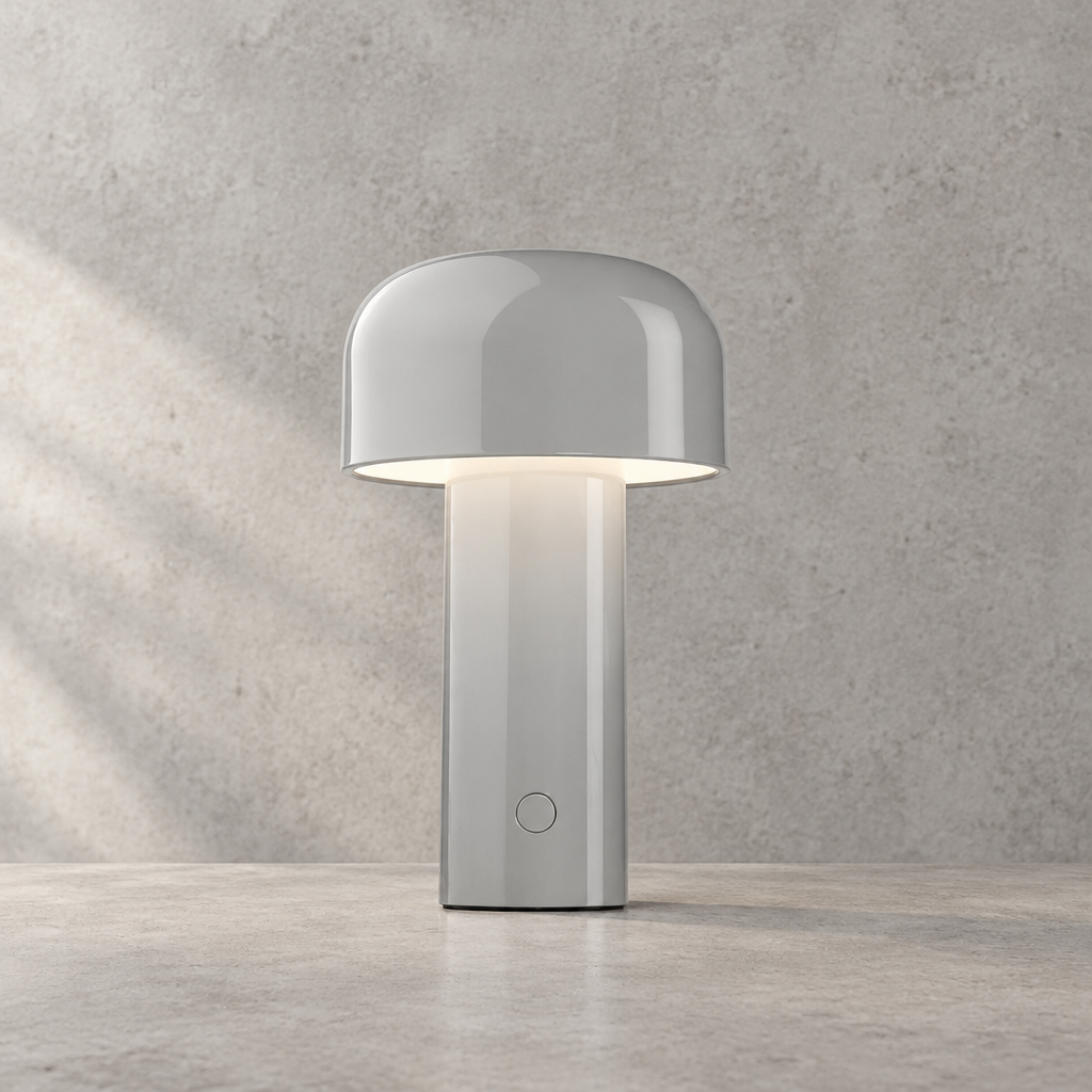 Glossy light gray lamp with round touch button, glowing under its dome shade 32