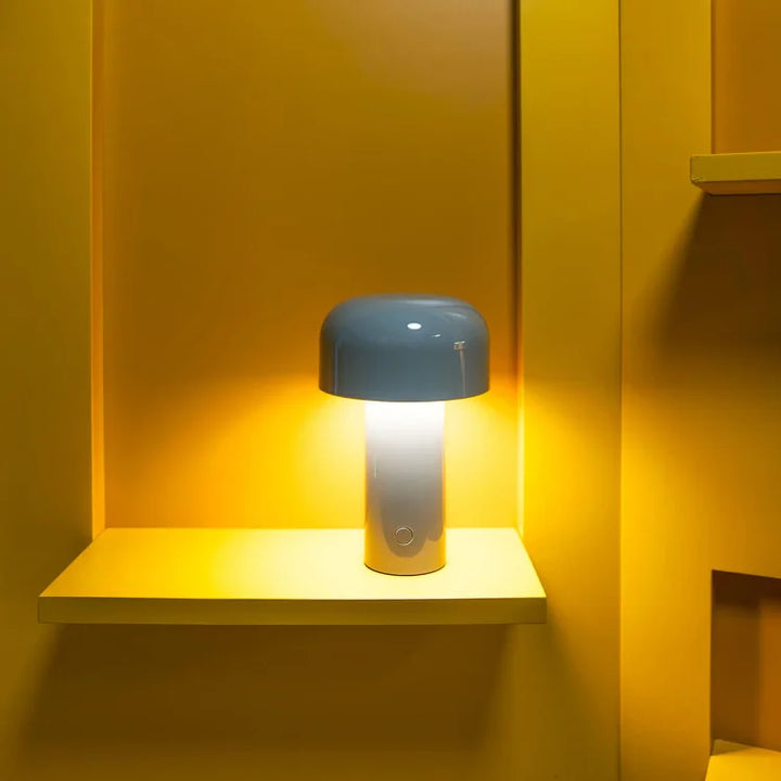 Blue-capped lamp with a white base glowing on a shelf in a bright yellow niche 11