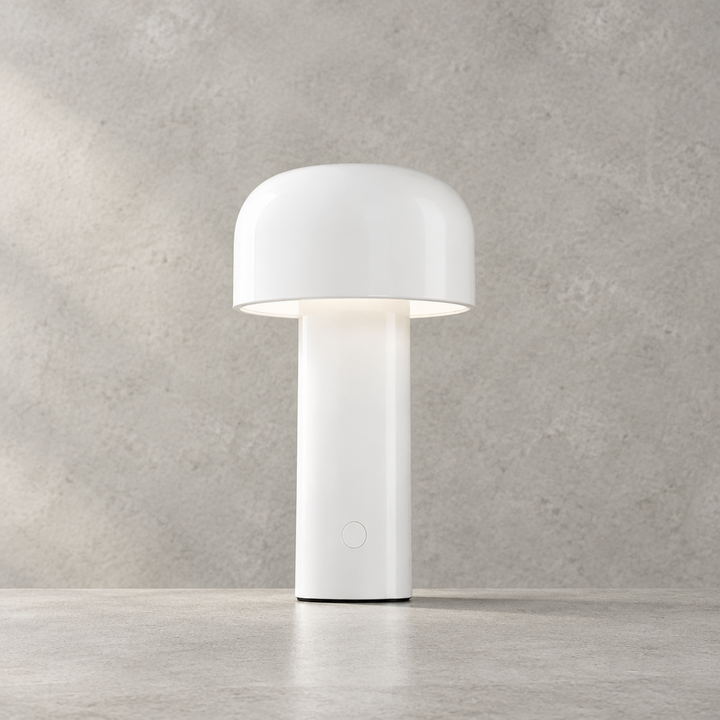 Glossy white lamp with dome shade and round touch button on its base, lit on concrete 28