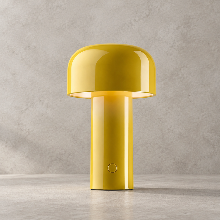 Glossy yellow lamp with dome shade and round touch button, lit against a concrete backdrop 31