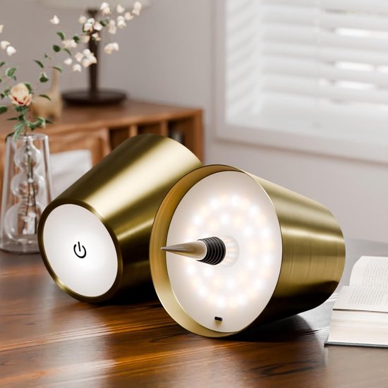 Two gold bottle lamps showing the touch power button and the LED ring with stopper.