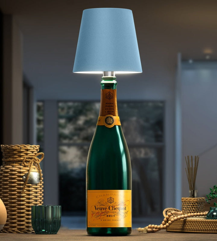 Light blue bottle lamp on a dark green champagne bottle.