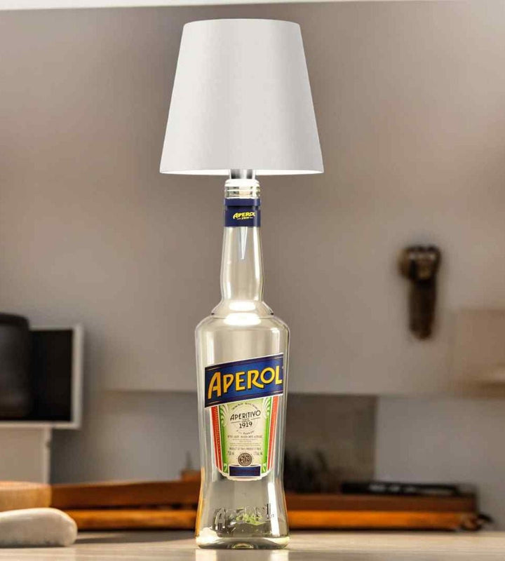 White bottle lamp on a clear glass aperitif bottle.