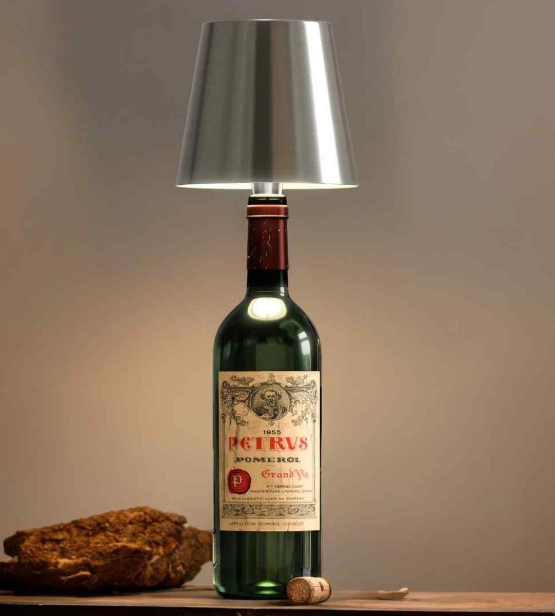Silver bottle lamp on an old green wine bottle.