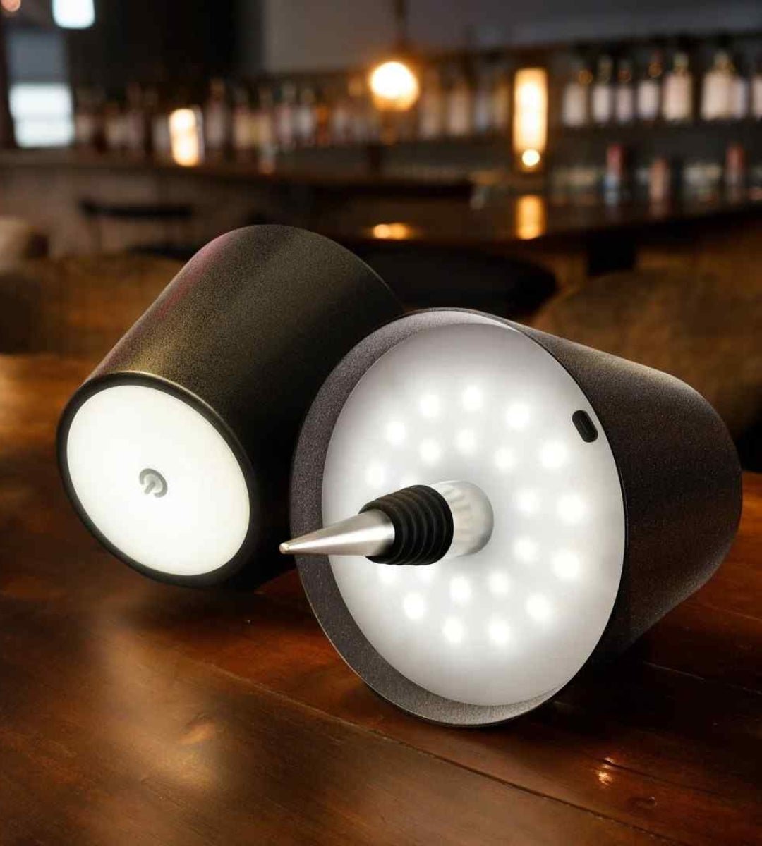 Two black bottle lamps showing the round touch button and the LED panel with bottle stopper.