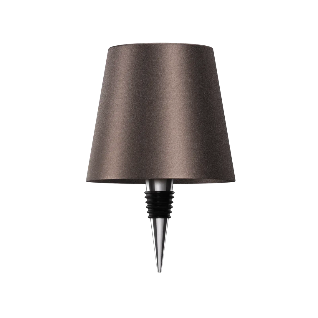 Dark brown bottle lamp with a chrome and black rubber bottle stopper on a white background.