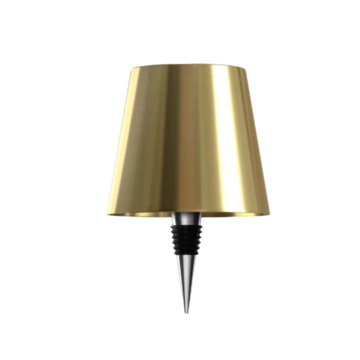Gold bottle lamp with a chrome and black rubber bottle stopper on a white background.