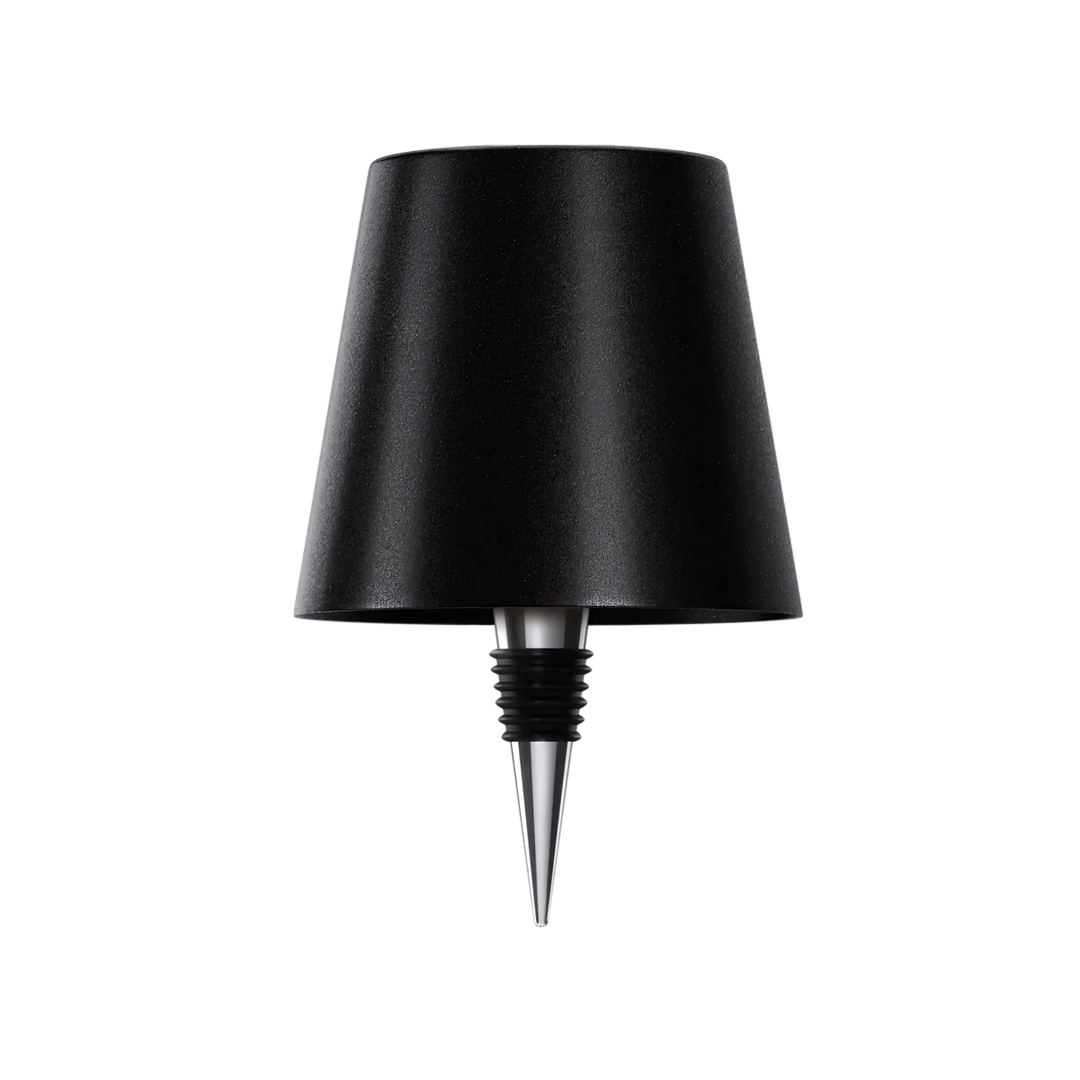 Black bottle lamp with a chrome and black rubber bottle stopper on a white background.