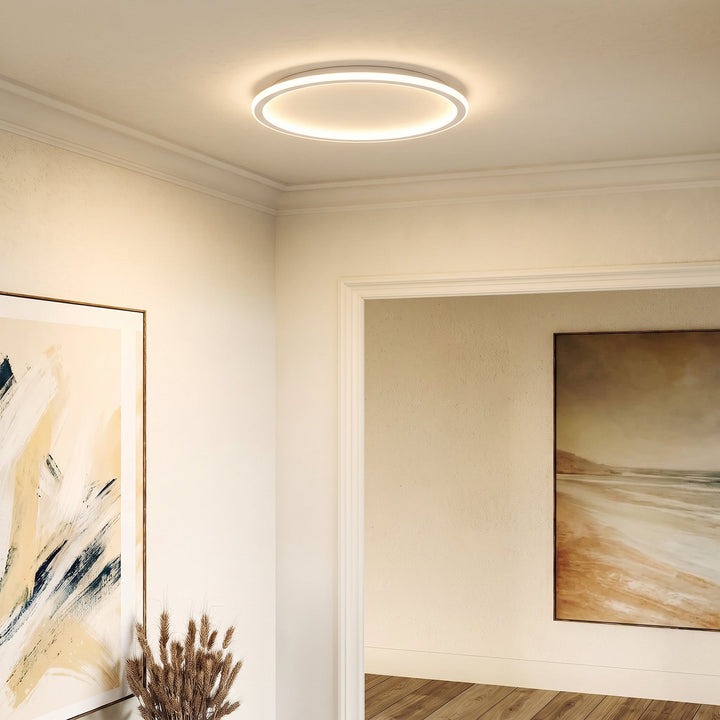 White round ceiling light switched on in a hallway