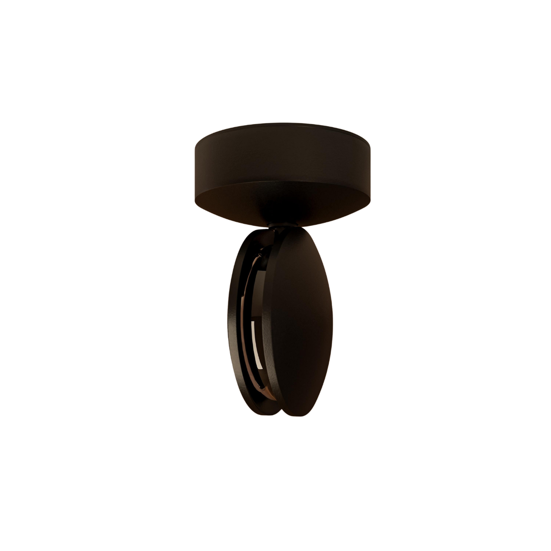Black LED wall sconce detail showing a round ceiling base and turned head.