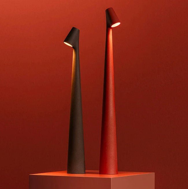 Another view of two lit rechargeable LED table lamps in dark brown and terracotta red.