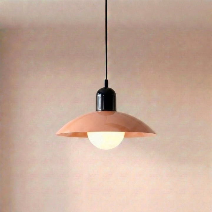 Close view of a beige Macaron Pendant Light with the bulb lit below the shade.