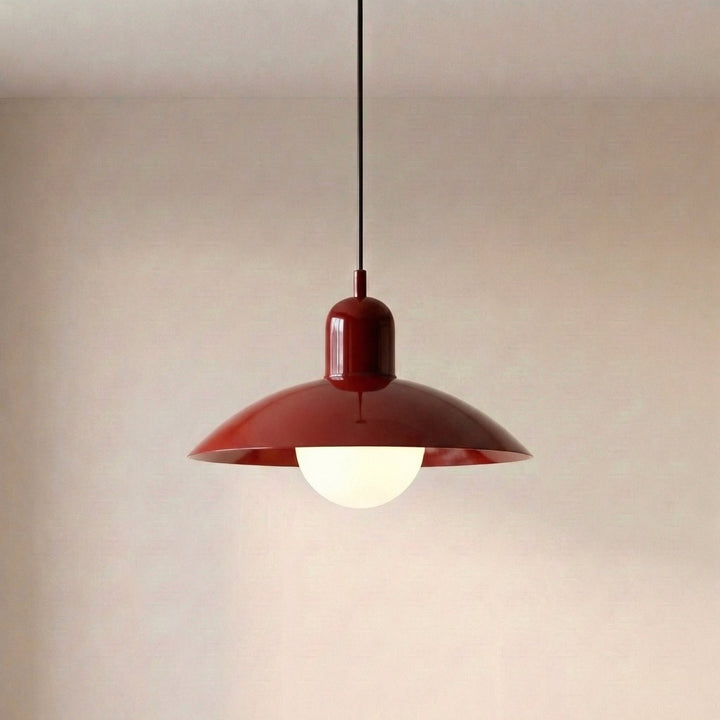 Close view of a beige Macaron Pendant Light with the bulb lit underneath.