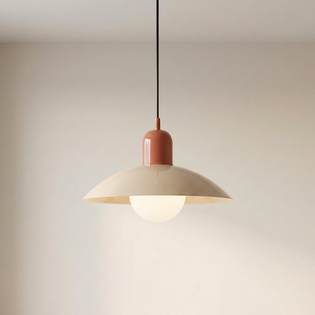 Beige Macaron Pendant Light against a wall with the bulb glowing.