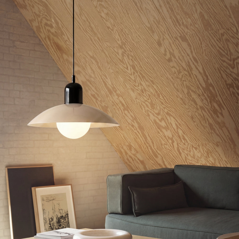 Beige Macaron Pendant Light by a sloped ceiling and sofa.