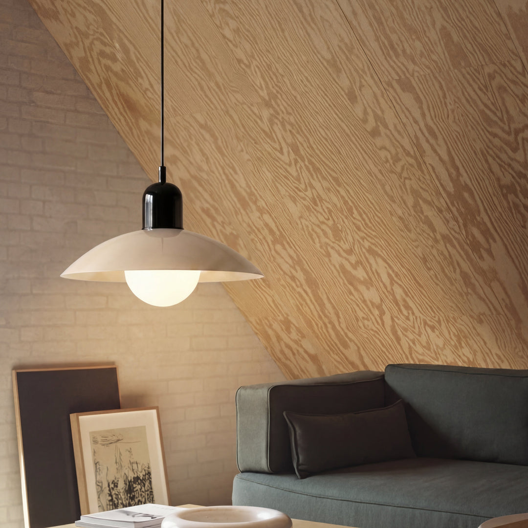 Beige Macaron Pendant Light by a sloped ceiling and sofa.