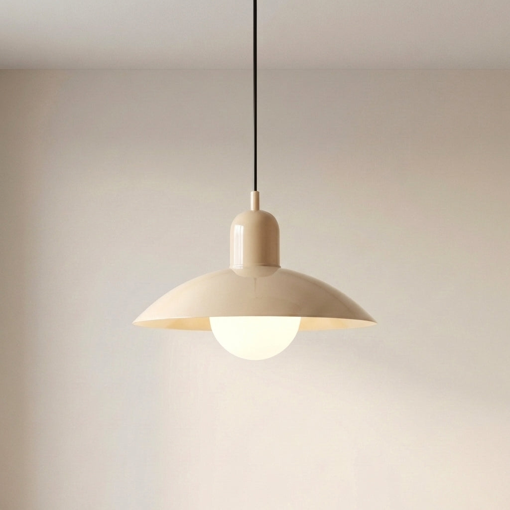 Beige Macaron Pendant Light against a light wall with the bulb glowing.