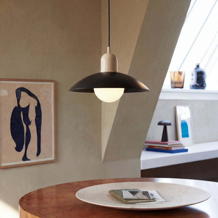 Beige Macaron Pendant Light hanging above a wooden table.