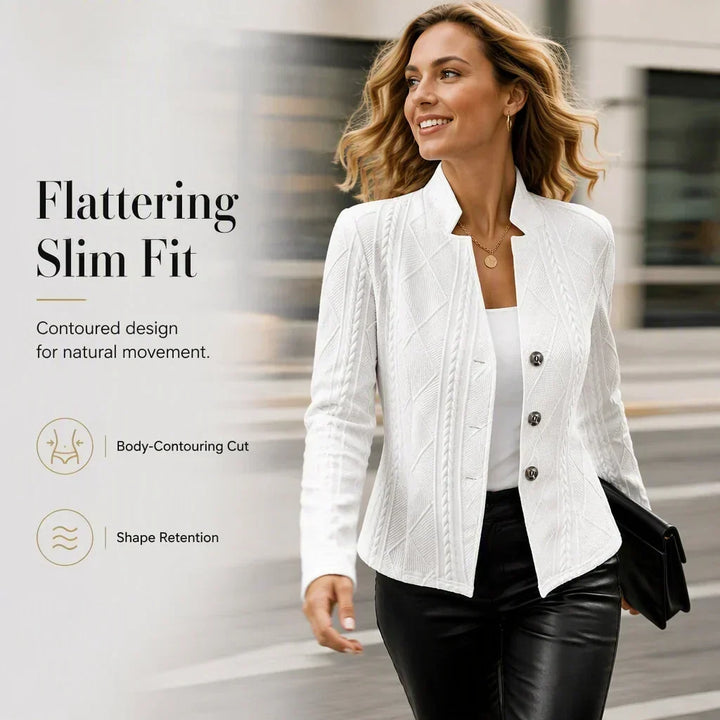 Woman in a white textured blazer and black leather pants striding down a street holding a clutch 18