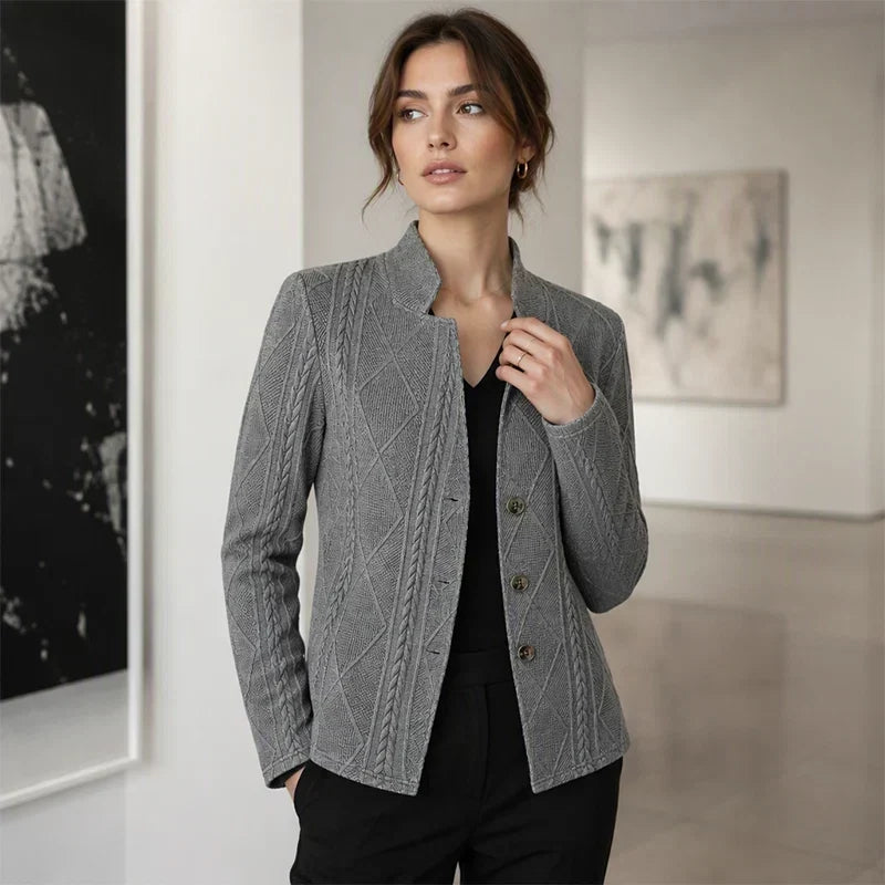 Gray textured blazer worn over a black V-neck top by a woman in an art gallery 11