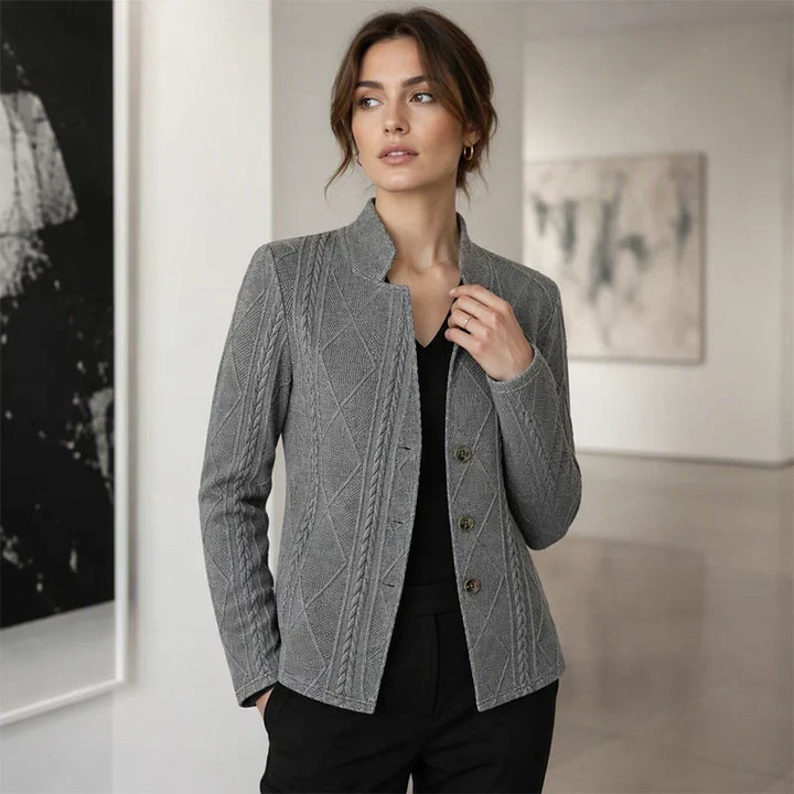 Gray textured blazer worn over a black V-neck top by a woman in an art gallery 11